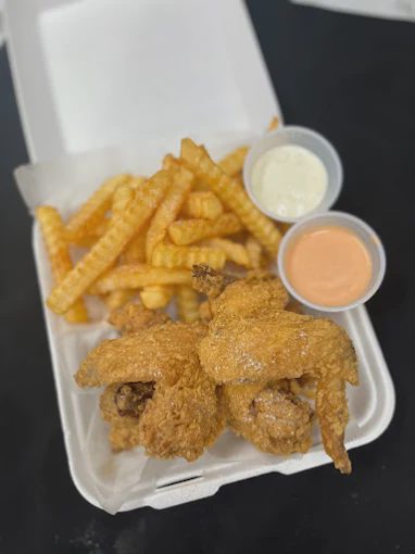Chicken and fries with dipping sauces.